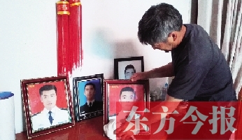 沉浸在悲痛之中的魯有海，擦拭著孩子的遺照